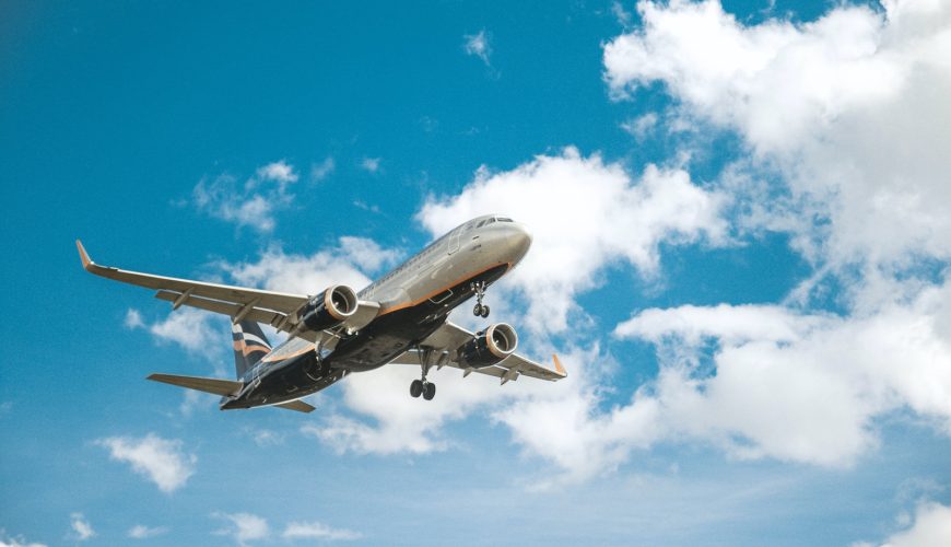 white airplane under blue sky during daytime